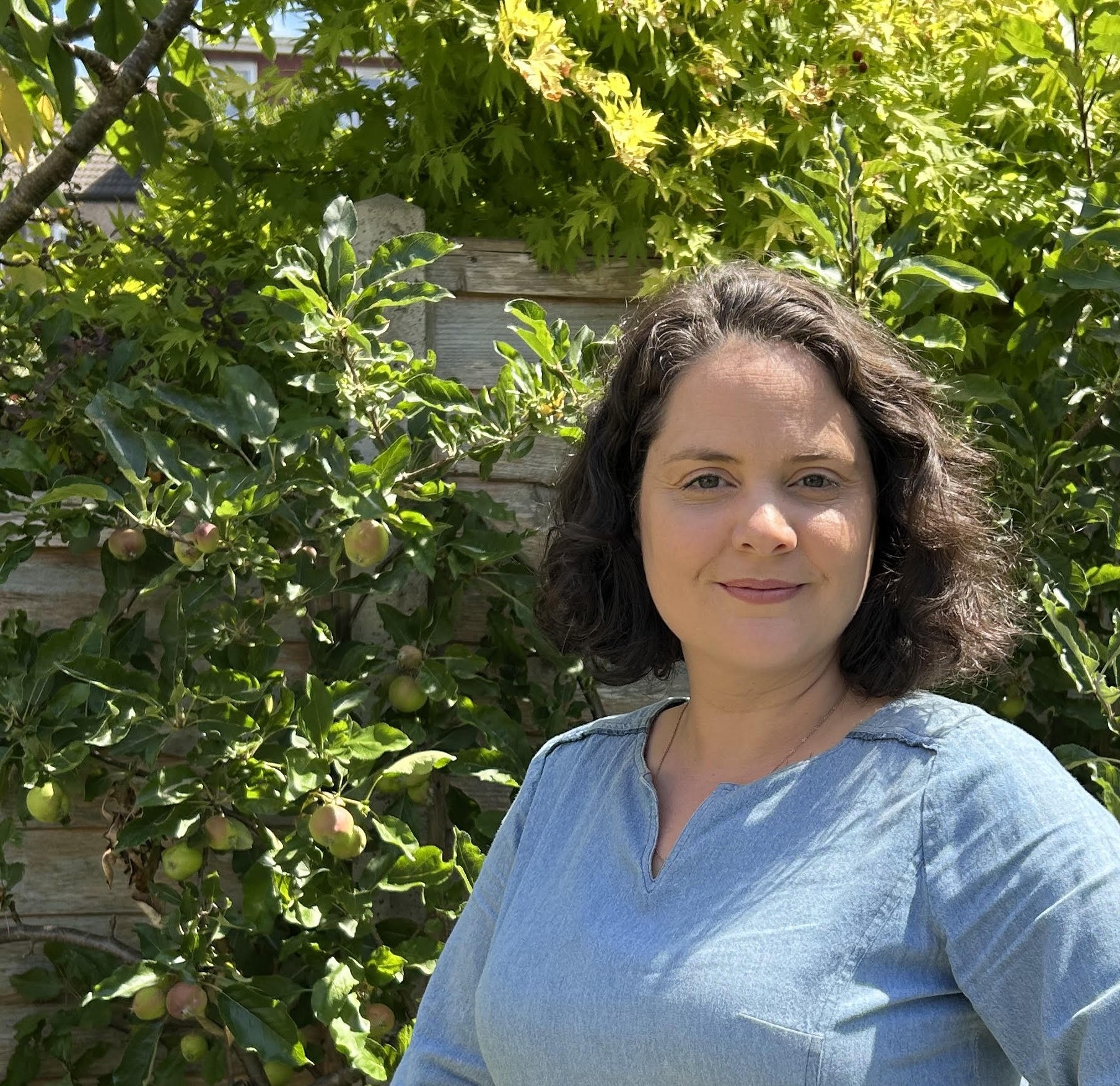 a picture of the therapist in the sun with an apple tree in the background